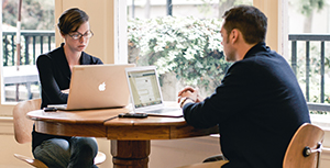 man and woman working at a computer