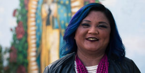 Joyce del Rosario smiling in front of artwork