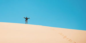 man on sand dune