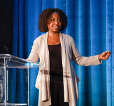 Brenda Bertrand speaking at a podium